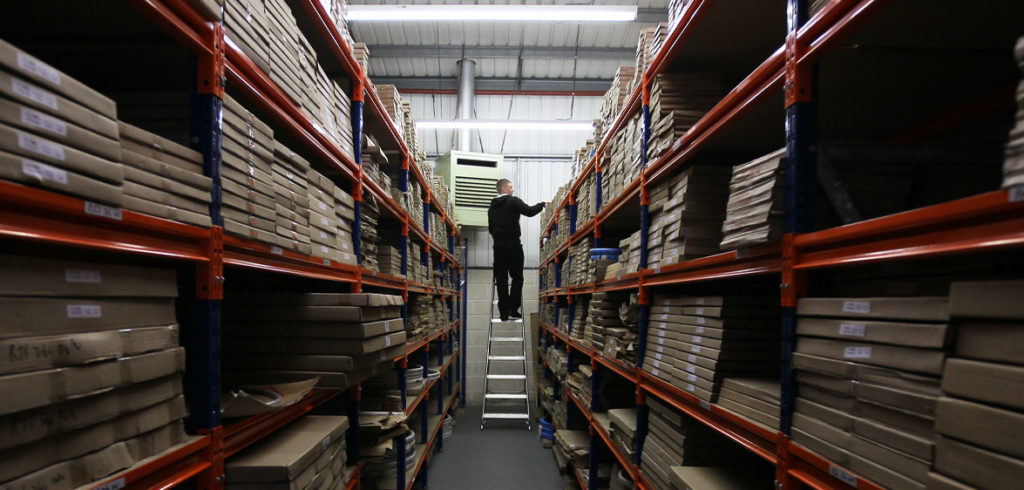 man in a stock room getting stock